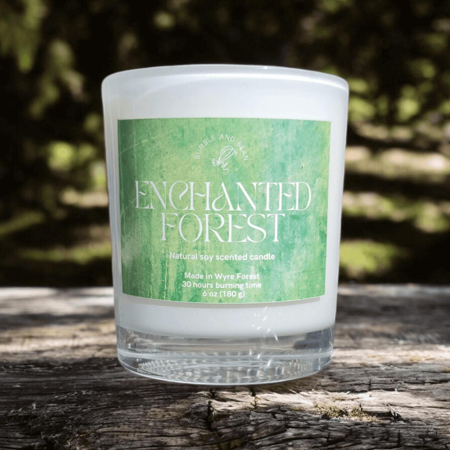 Close-up of Enchanted Forest candle with cotton wick and smooth natural wax