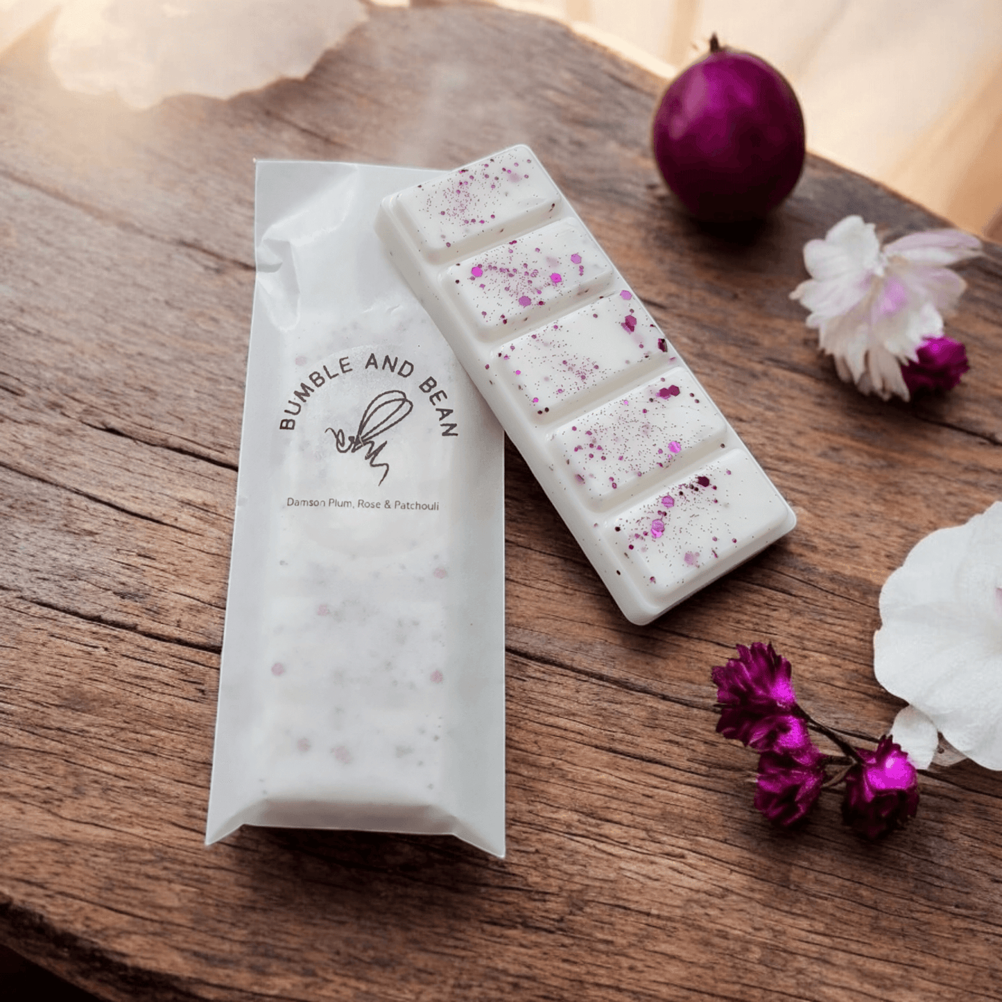 Close-up of Damson Plum, Rose, and Patchouli wax melt with rich rose petals and earthy patchouli scent