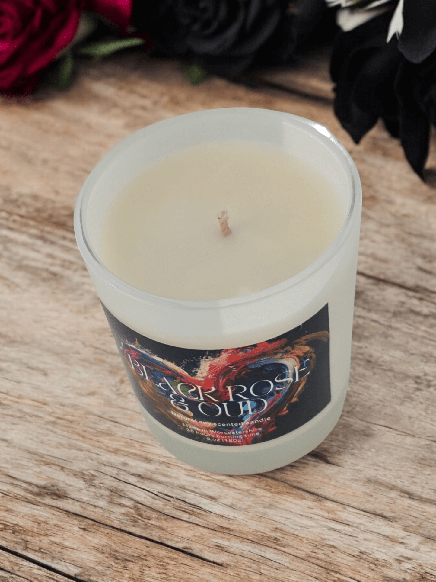 Close up of Black Rose and Oud scented candle with smooth all natural wax and cotton wick