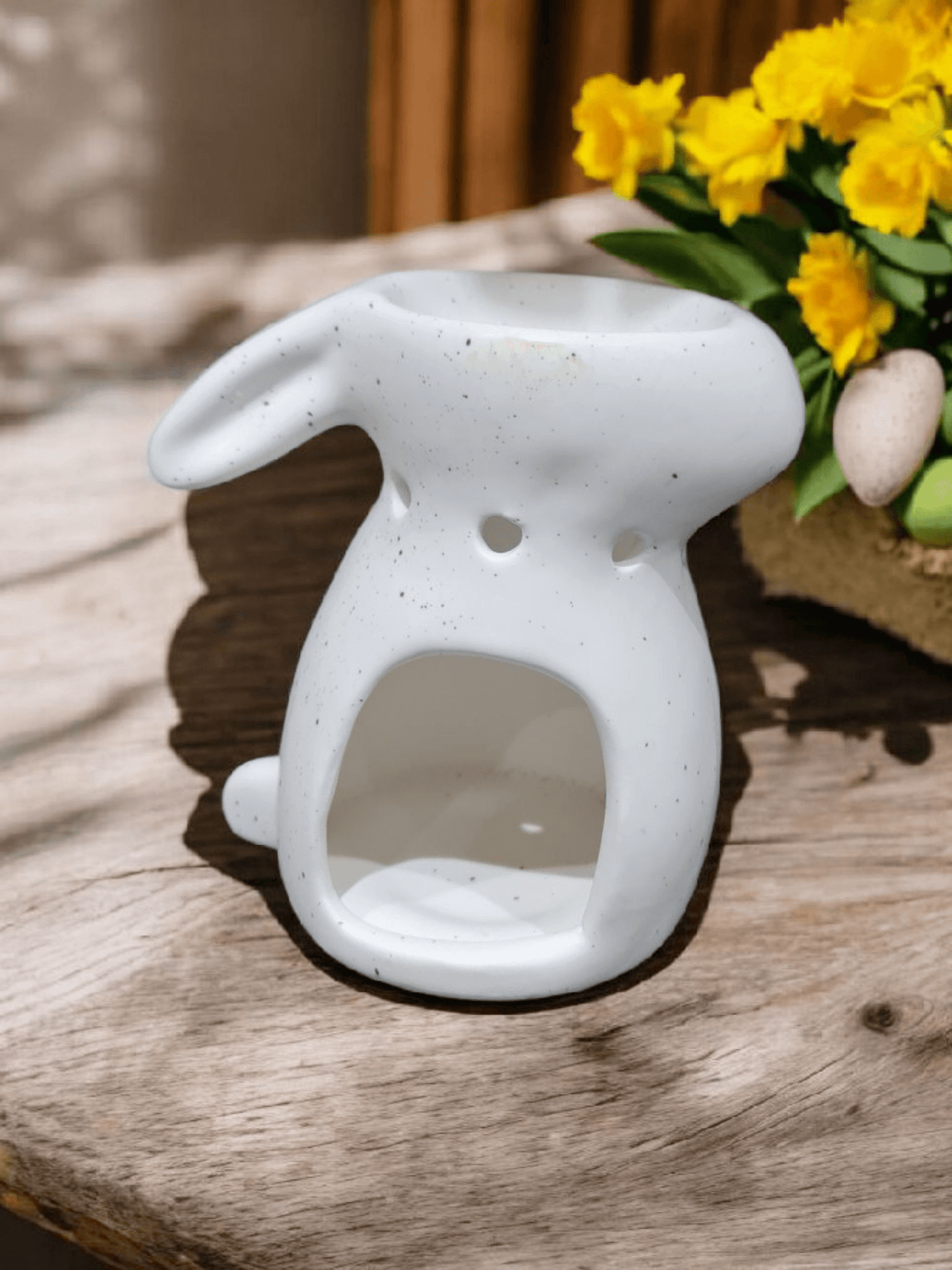 Glow from bunny-shaped wax melt burner with melted wax and soft, cozy fragrance